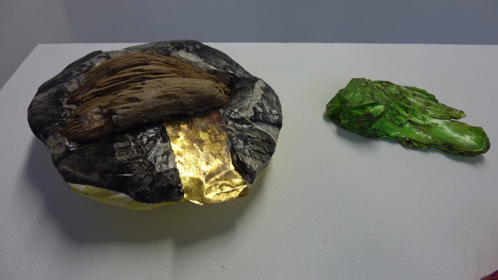 Excavated Realities — Close-up: wood and gold leaf elements; textured green form