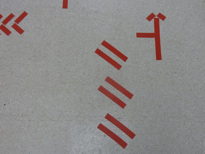 'wait' — Detail — road and street markings recompiled on the gallery floor